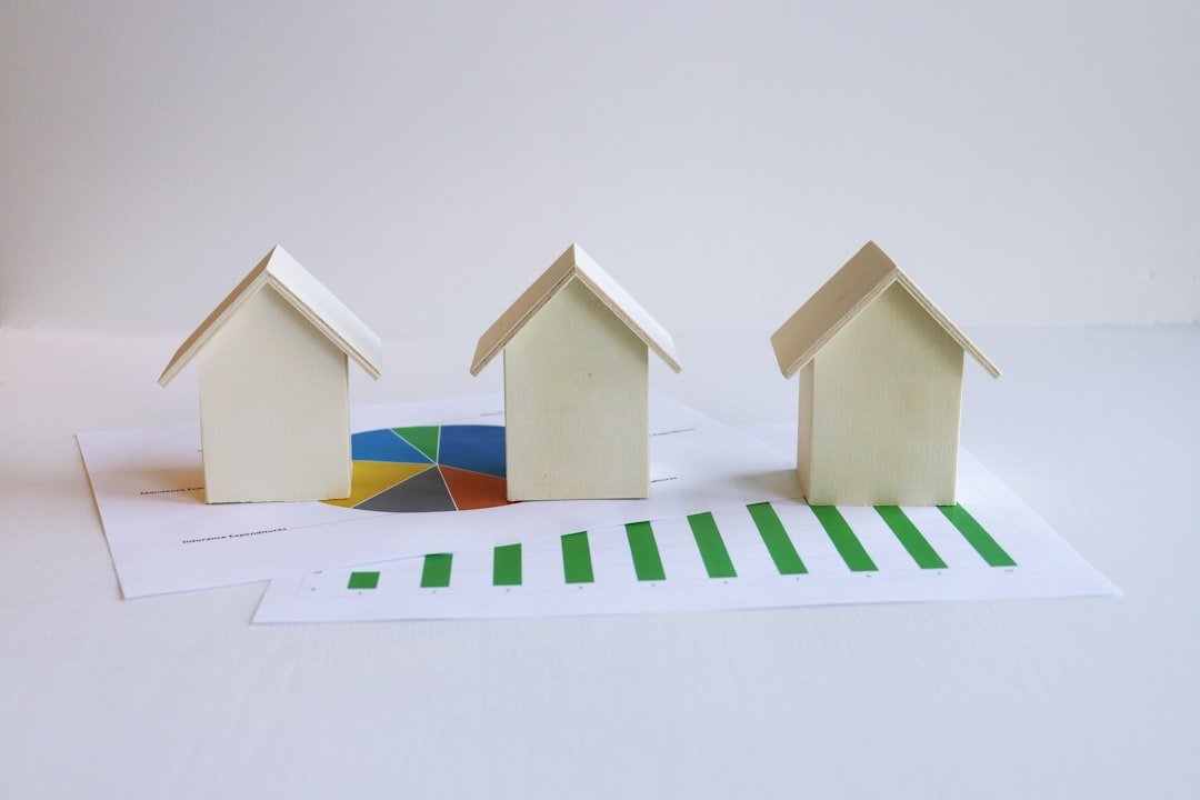 three-small-houses-sitting-on-top-of-a-piece-of-paper-mjjhpcs-g