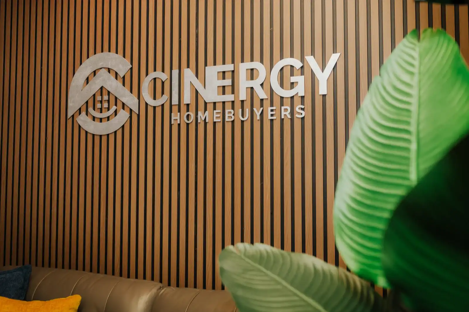 Backyard view of a private residence featuring a wooden privacy fence and green grass lawn area.